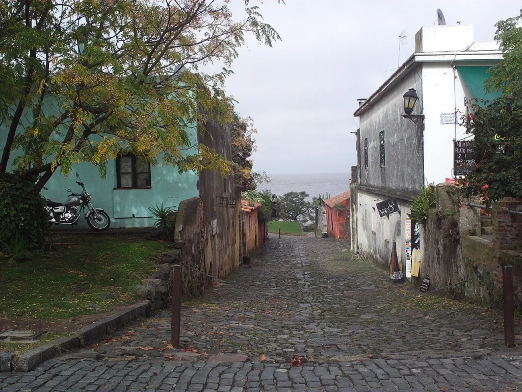 Stone street and low houses on Calle de los Suspiros in Colonia