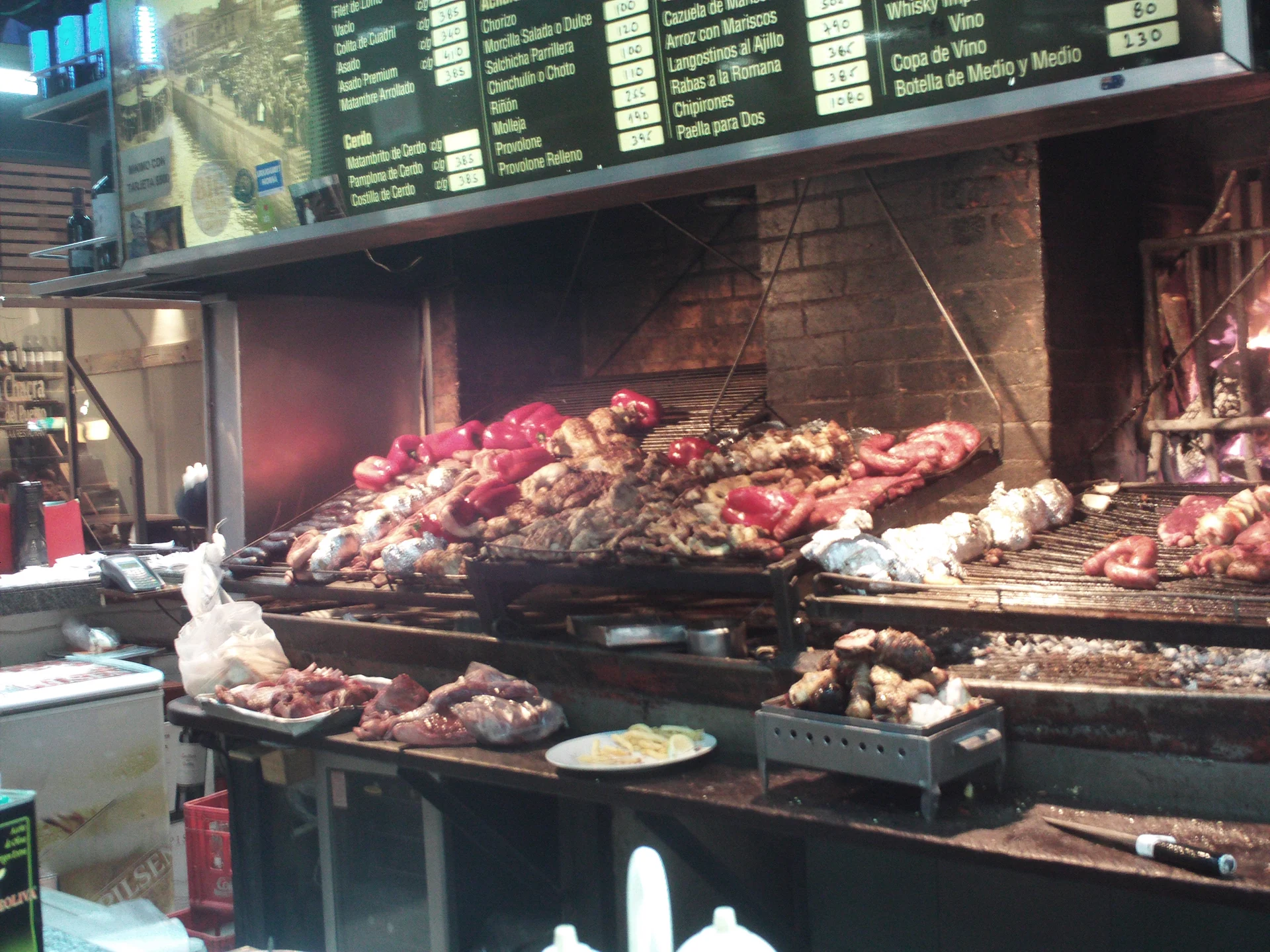 Food cooking over a parrilla at Mercado del Puerto
